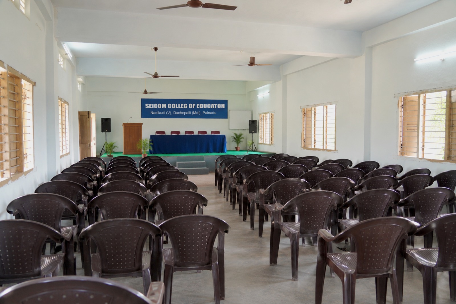 SEICOM seminar hall with rows of chairs facing a stage