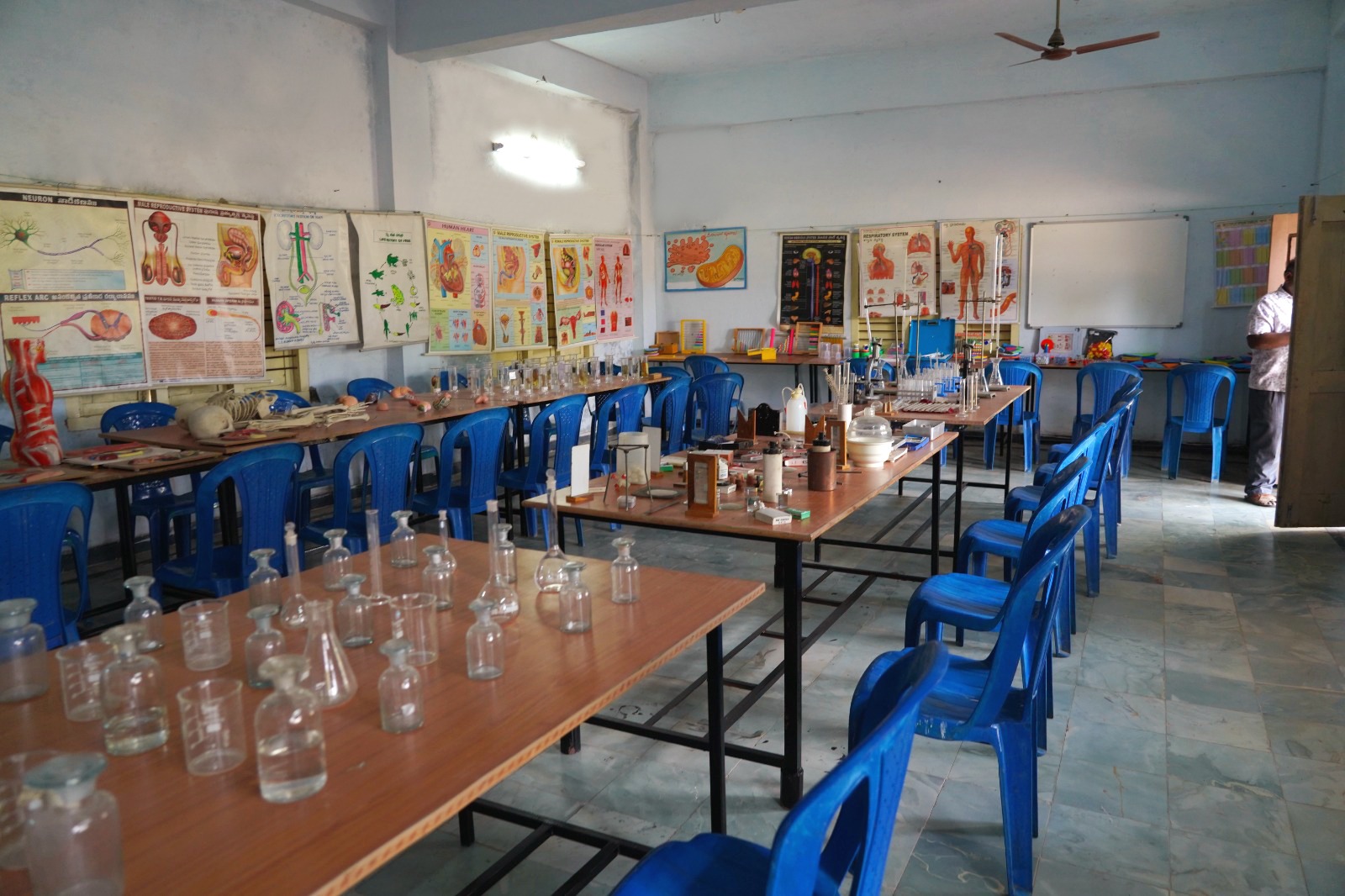 Wide view of the SEICOM science laboratory with glassware and anatomy charts